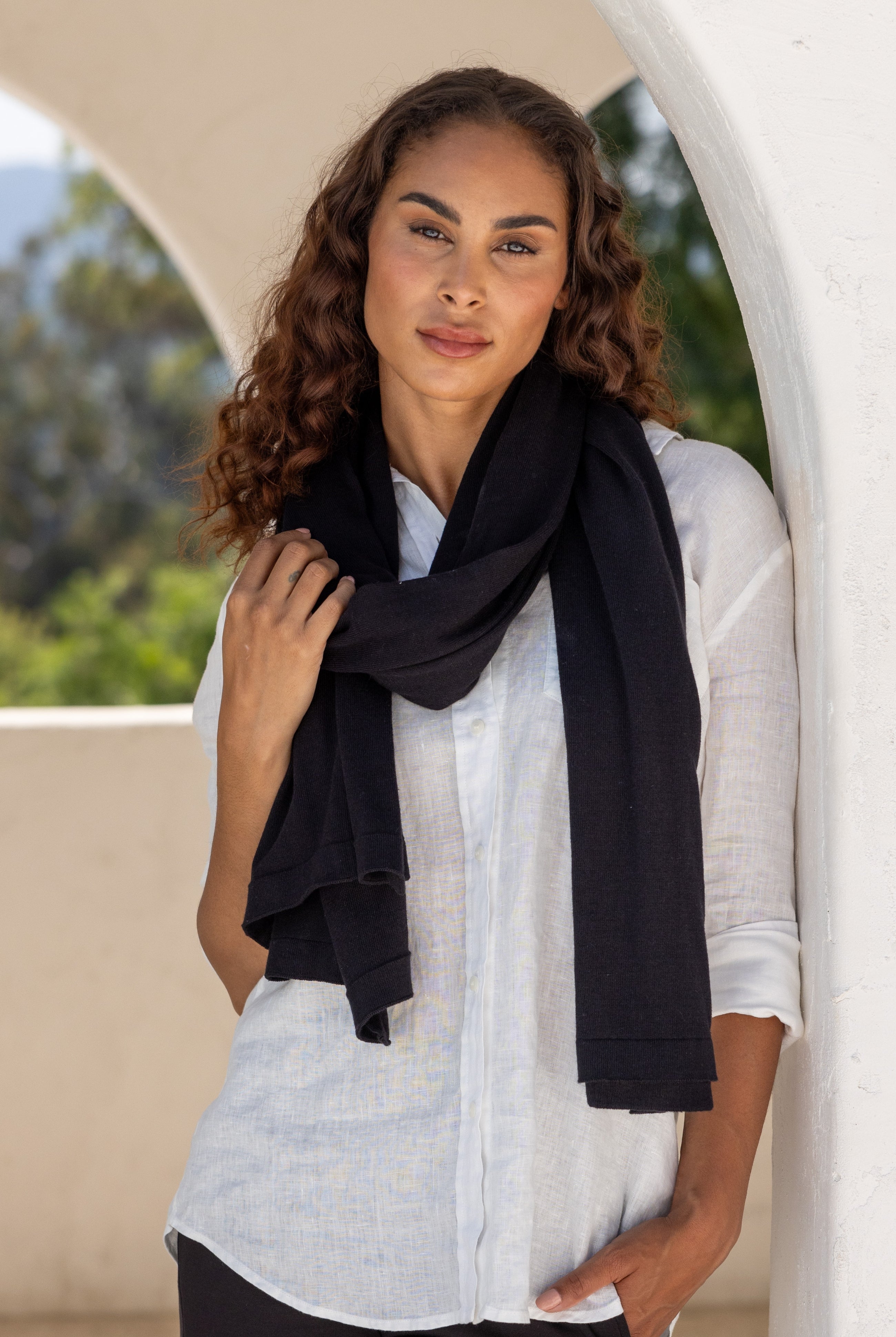 Woman wearing a Black Scarf wrapped around her neck